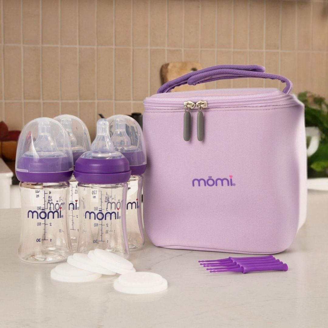 giftable mōmi breast-like bottle set with gray collars, gray milk cooler bag, milk storage discs and cleaning tools ready for feeding baby on-the-go